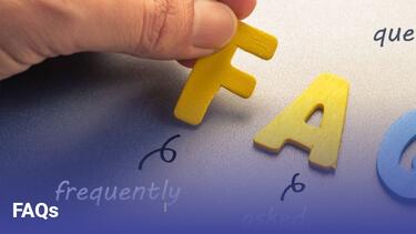 A hand holding the F of FAQ