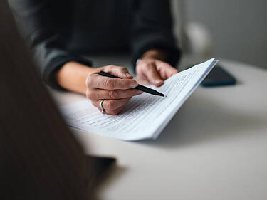 A person pointing out something on a paper